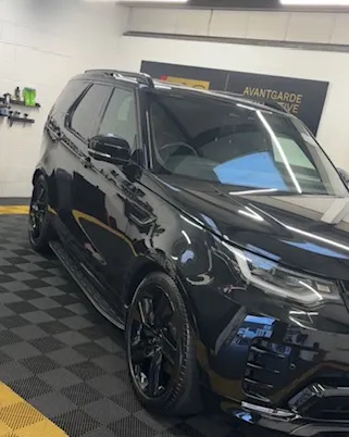 Black Land Rover Discovery Commercial gleaming in the Avantgarde unit